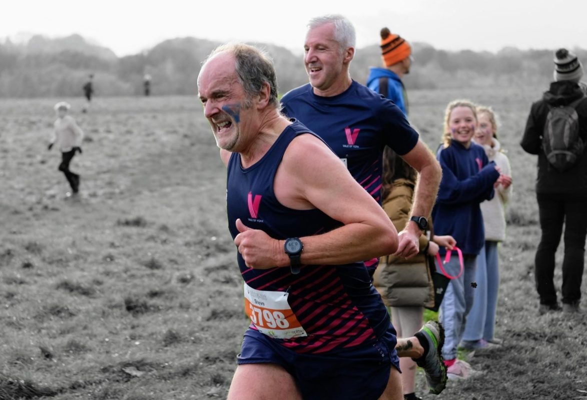 Two Vale of York masters athletes sprinting for the line at a PECO cross country race