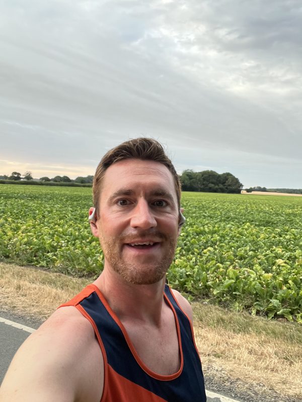 Richard Johnson pausing for a selfie beside a field while out training for the Great North Run